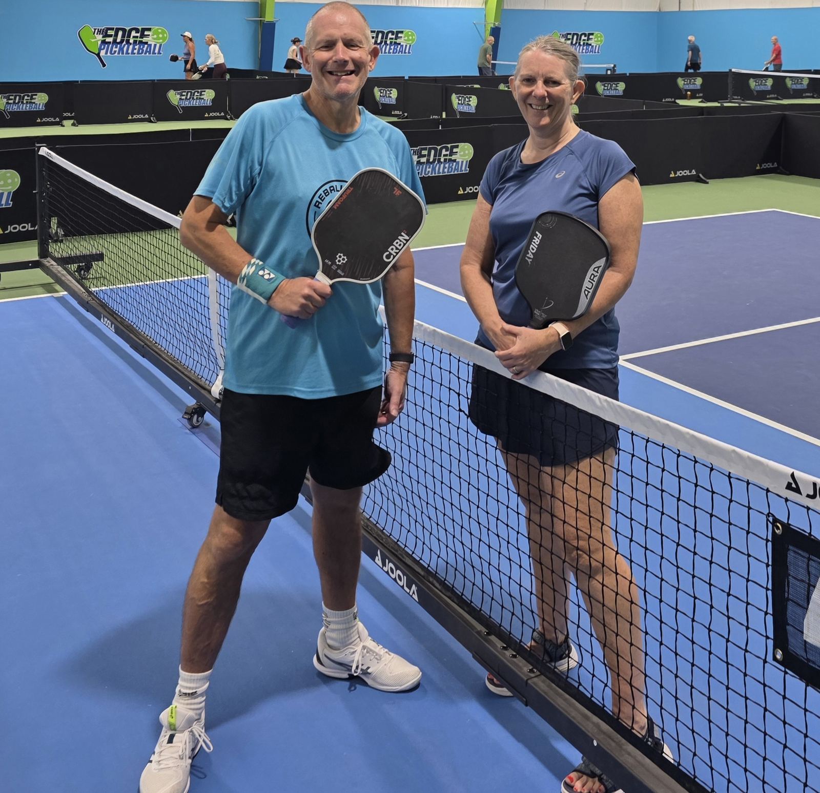 Dave and his partner courtside at The Edge Pickleball